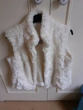  White faux fair fully lined with soft satin vest.Oasis beautiful on.