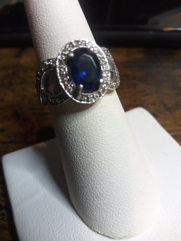 Sterling Silver Ring w. 8.3x6.8 oval Lab Sapphire Surrounded By Cubic Zirconia 