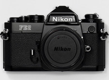 NEW in BOX UNUSED Nikon FE2 35mm Black Camera W/ Titan Shutter We are US seller.