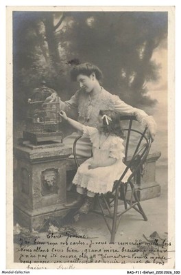 BADP11-0956-CHILD - A CHILD AND HER MOTHER WITH A BIRD CAGE