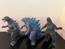 A 3 pack of huge Godzilla action figures