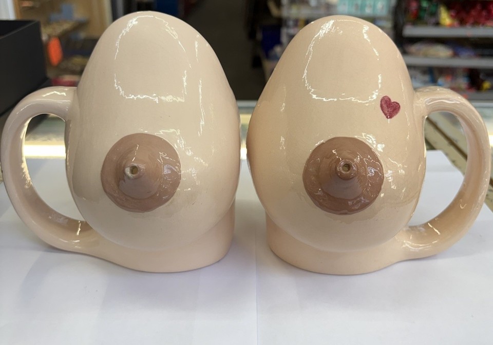 A matched pair of 1970s ceramic novelty boob mugs in great condition — genuinely rare retro kitsch that belongs in a mid-century man cave.