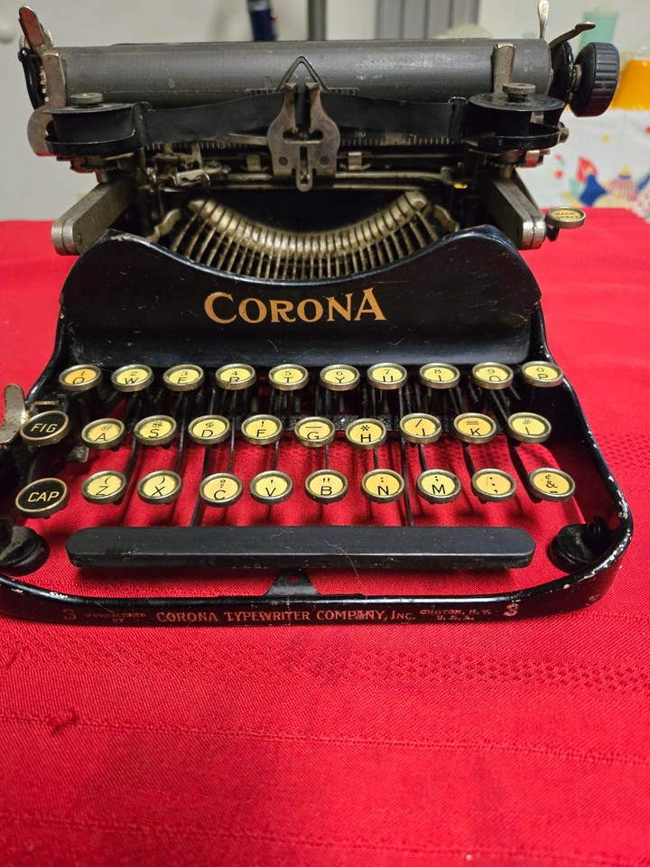 A 1917 Corona No. 3 folding typewriter — one of the most iconic portable machines ever made, small enough to fit in a briefcase and over 100 years old.