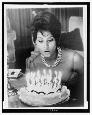 Photo:Birthday blowout,Sophia Loren,cake,candles,blow,1961