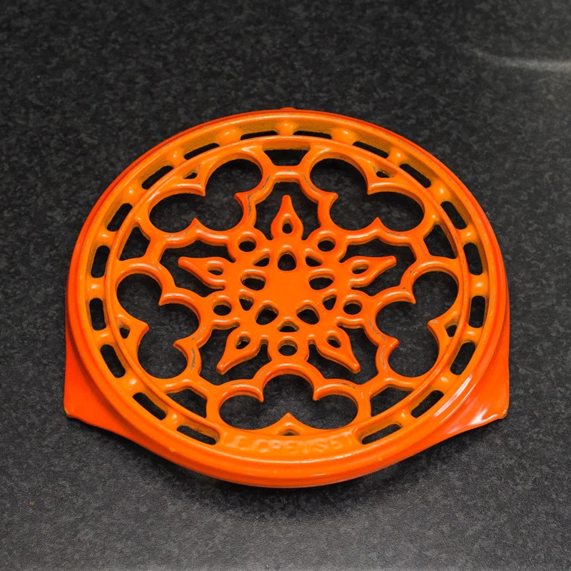 cast iron trivet in volcanic orange