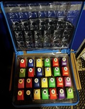 Alphabet Paper Punch Set organized in a clear carrying case. Used