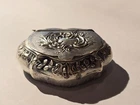 small silver metal pill box