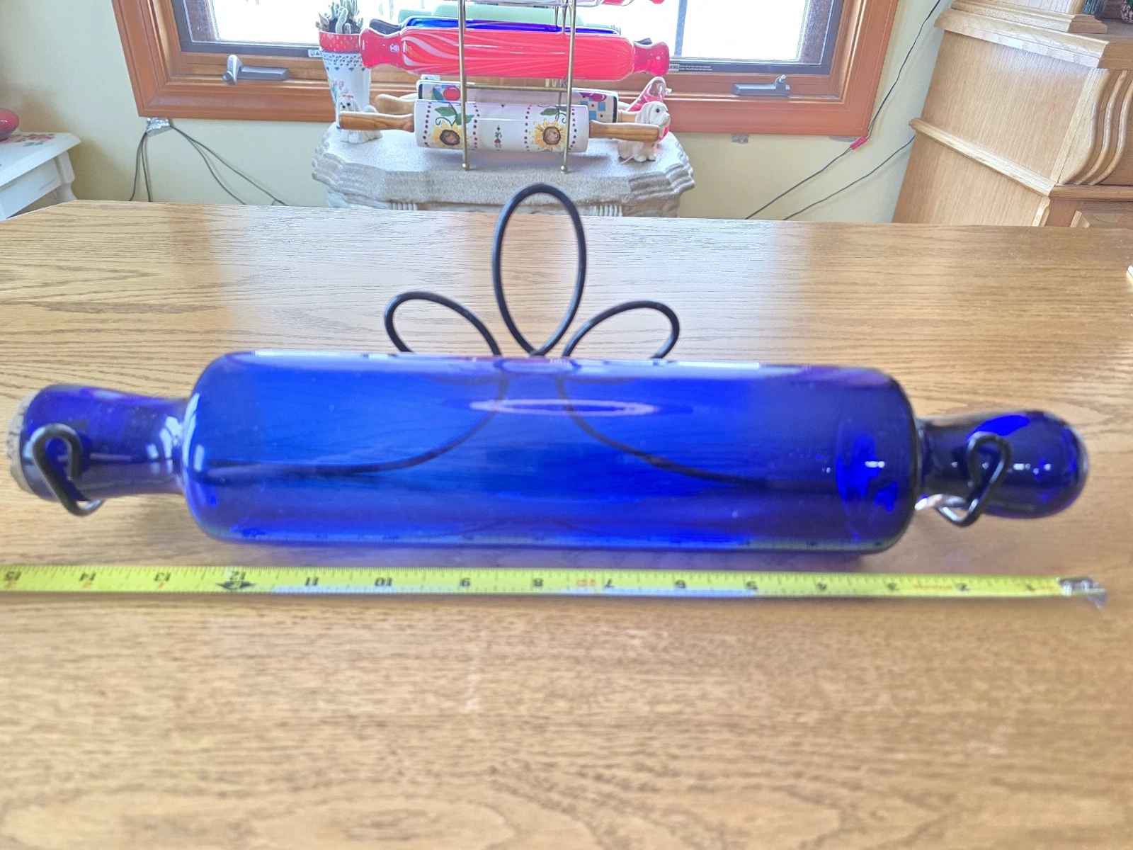 This is a vintage or antique cobalt blue glass rolling pin