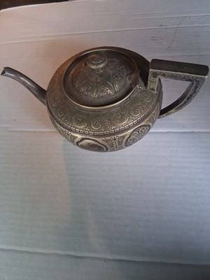 An electroplated teapot by Fenton Brothers with intricate etched designs.
