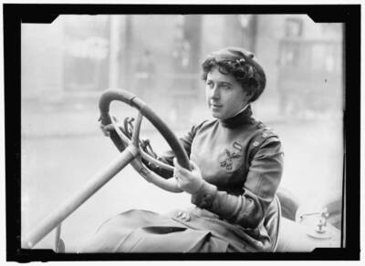 Race car driver Joan Newton Cuneo, seated in racing car, facing le- Old Photo