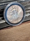 2024 (P) $1 American Silver Eagle Star Privy BU With Toning. In Capsule