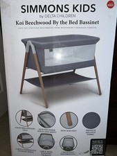Delta Children Haven Beechwood Bassinet Solid Beechwood Legs Striped Sheet Mesh