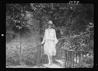 Photo:Unidentified woman, standing outdoors
