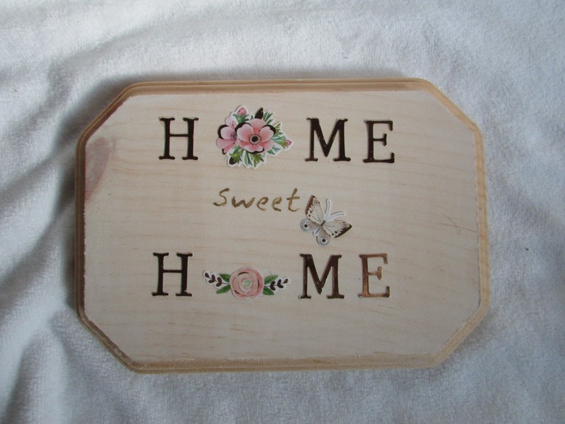 small Home sweet Home sign with gold lettering and pink flowers