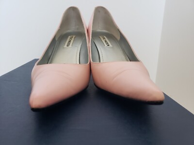 peach dress silver shoes Peach Coral Dress And Silver Shoes Female With Stylish Hairdo And Thick  Earrings Demonstrating