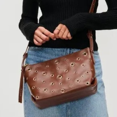 URBAN EXPRESSIONS TARAN GROMMETED VEGAN LEATHER CROSSBODY BAG