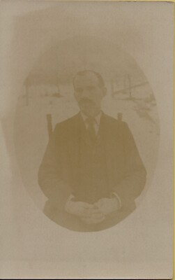 RPPC of STERN MAN WITH MUSTACHE in Suit Rocking Chair Real Photo 1910s Solio