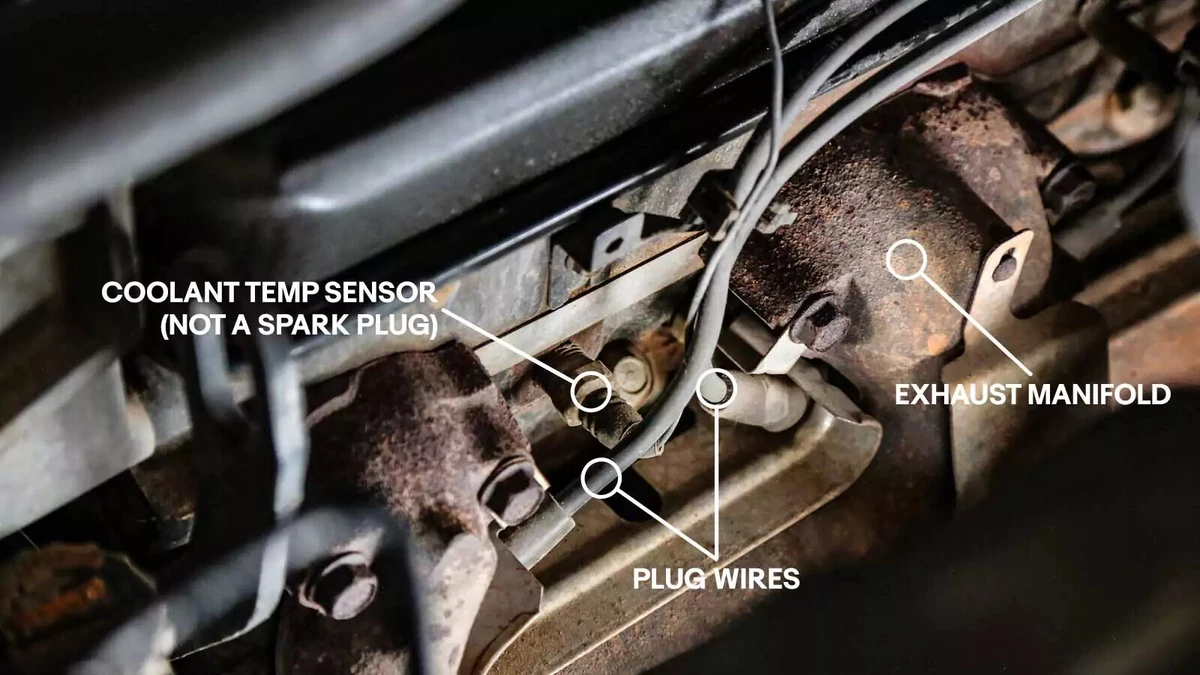 An annotated photograph shows the location of the spark plug wires, coolant temperature sensor, and exhaust manifold.