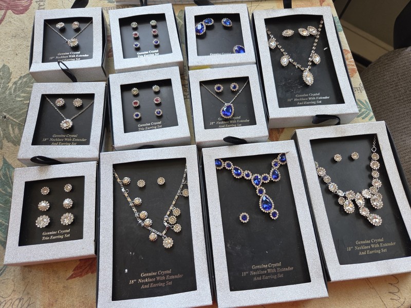 A lot of 11 still in the box crystal jewelry setsTo the whole
