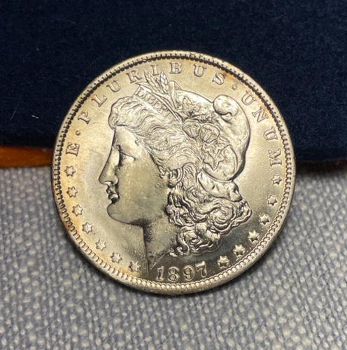 (#100674).  Morgan Dollar: 1897 O   ....  AU details.  Cheek as been tooled