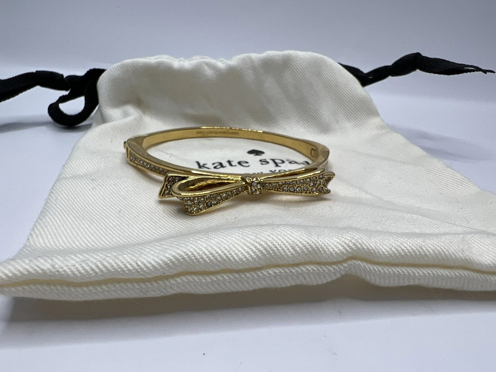 Bracciale Kate Spade fiocco strass tono oro con sacchetto antipolvere