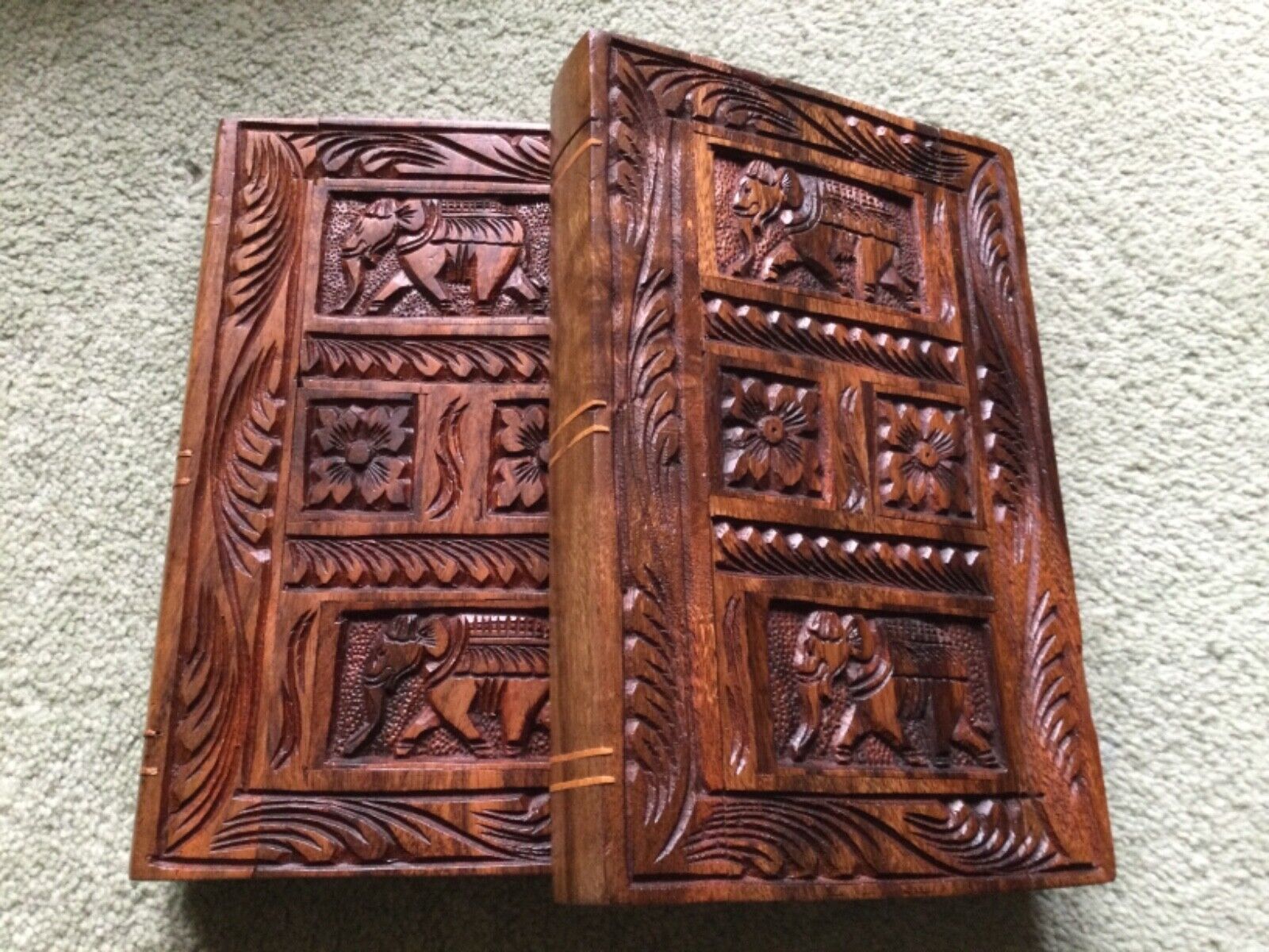 Two hand carved highly decorative solid wooden book ornaments