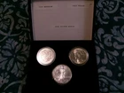 Three Silver Dollars Uncirculated 1921 Morgan, 1923 Peace and 2000 Silver Eagle