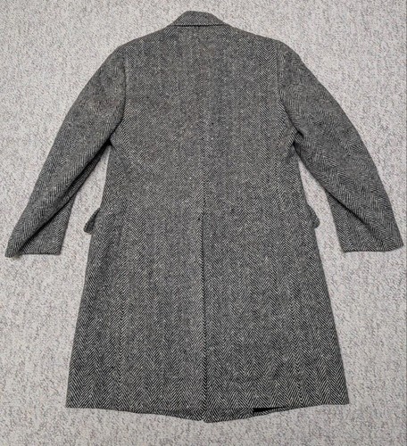 Gray wool vintage USA-made TWEED donegal coat with notch lapels, back zipper, and two front flap pockets on hanger.