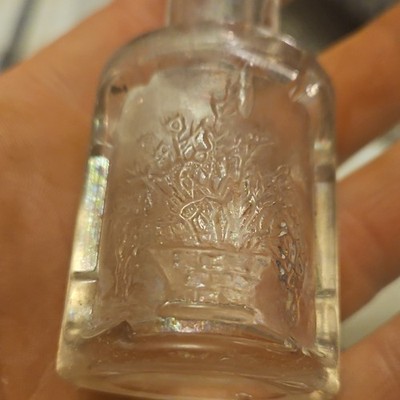 Clear Glass Bottle with Embossed Flower Basket Design Collectible
