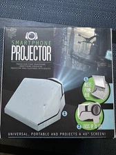 TEK Universal Smartphone Projector. New In Box Projects 40” Screen
