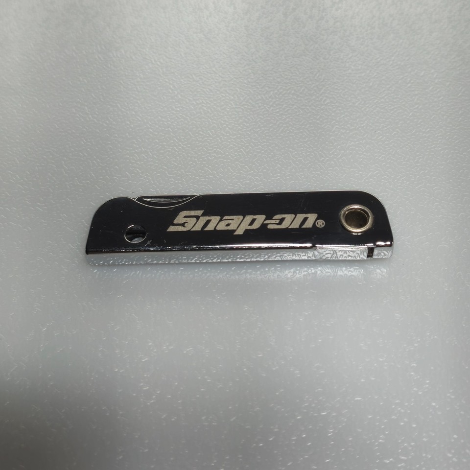Snap-on branded promo keychain pocket knife — the holy grail of mechanic-culture collectibles that actually fits in a stocking.