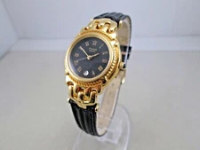 Pulsar lady's watch gold tone black dial Roman numerals date 26mm case size NOS 