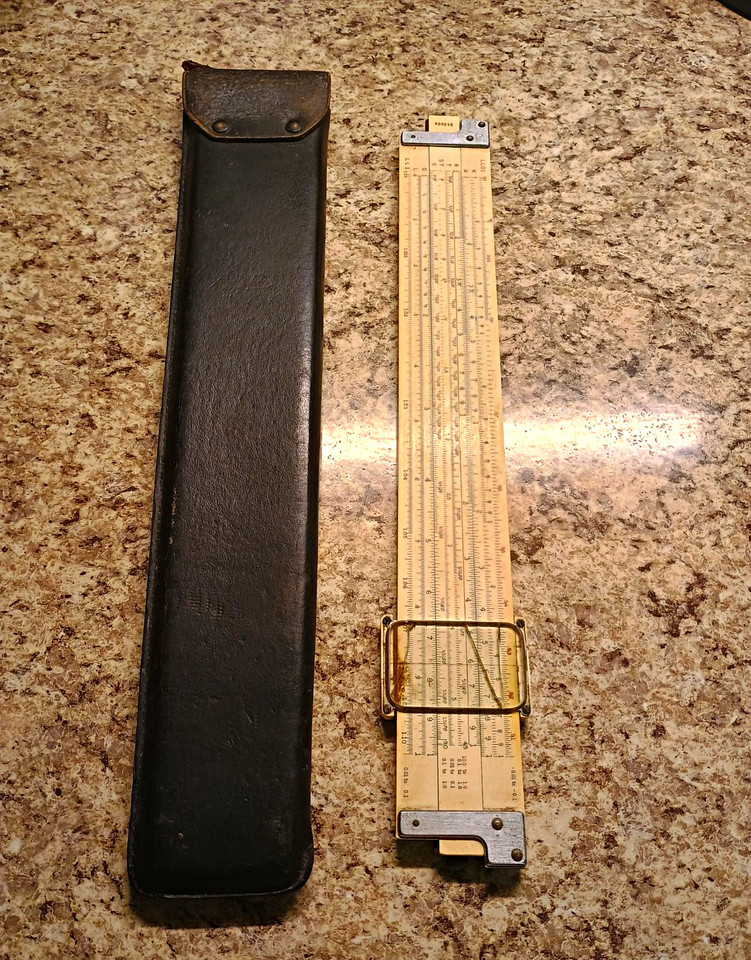 A classic wooden slide rule with a black leather case — the pre-calculator calculator that every engineer once lived by, now a charming nerdy artifact.