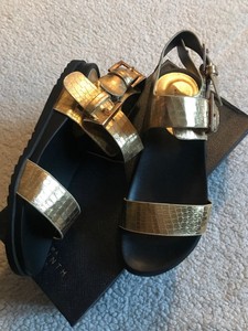 black and gold flatforms