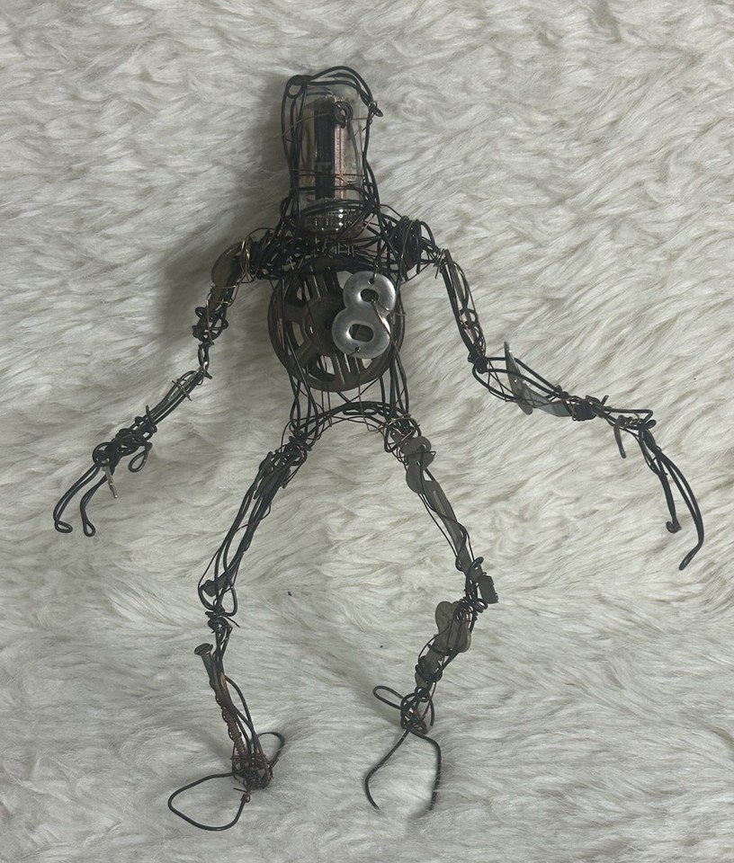 A one-of-a-kind hand-built robot sculpture assembled from found vintage parts — the kind of desk art that stops every visitor in their tracks.