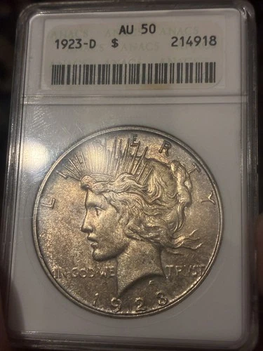 1923 D Peace Silver $1 Dollar ANACS AU50 in Old Soapbox Holder. Toned