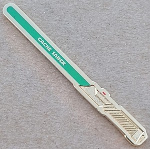 Cache Saber Geocoin - Shiny Gold w/ Green Glow - Activated & Adoptable - TB7DJHC