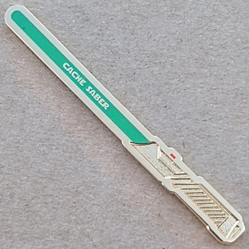 Cache Saber Geocoin - Shiny Gold w/ Green Glow - Activated & Adoptable - TB7DJHC