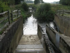 Photo 6x4 A very low River Adur passing through flow sluices? Shermanbury c2009