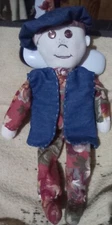 handsewn rag doll. 15" tall, button eyes. Denim beret and vest.