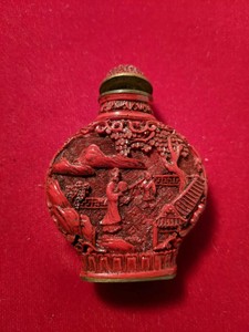 Vintage Chinese Cinnabar Snuff Bottle. carved with prunis trees & figures. with