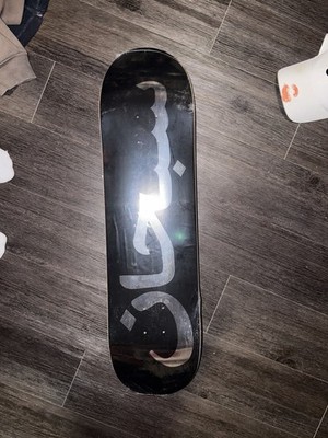 Supreme Black Skateboard Deck with Arabic Logo and Silver Graphic