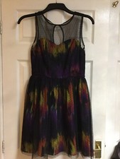 a multi coloured polyester dress with a black polka dot over lay dress