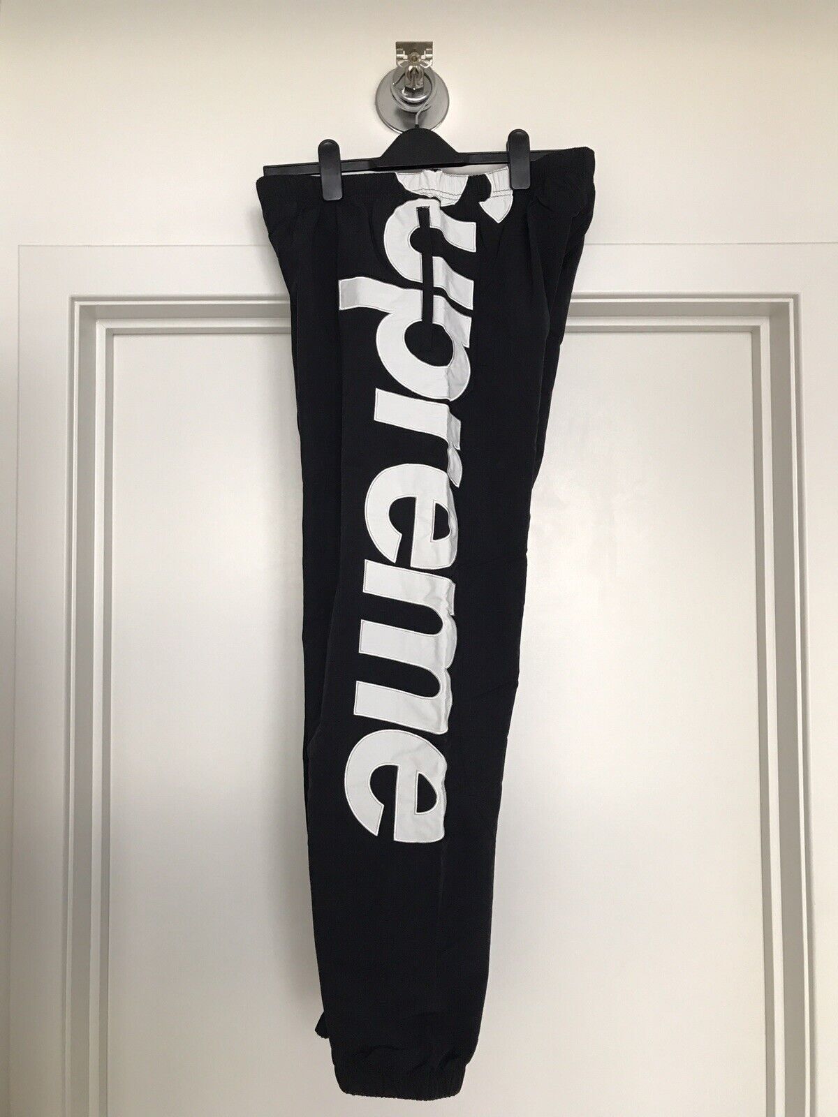 supreme spellout track pants