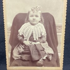 CABINET - identified, angelic little girl sits poised and stairs happily into th
