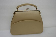 Vintage tan handbag with hand strap and shoulder strap and pockets