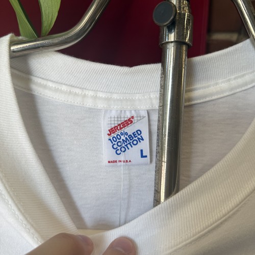 White 1990s Jerzees T-shirt with blue “100% Combed Cotton” label and red “Made in U.S.A.” text, men's XL.