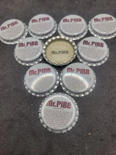 LOT OF 10 MR. PIBB GRAY UNUSED BOTTLE CAP WITH MR. PIBB INSIDE CAP