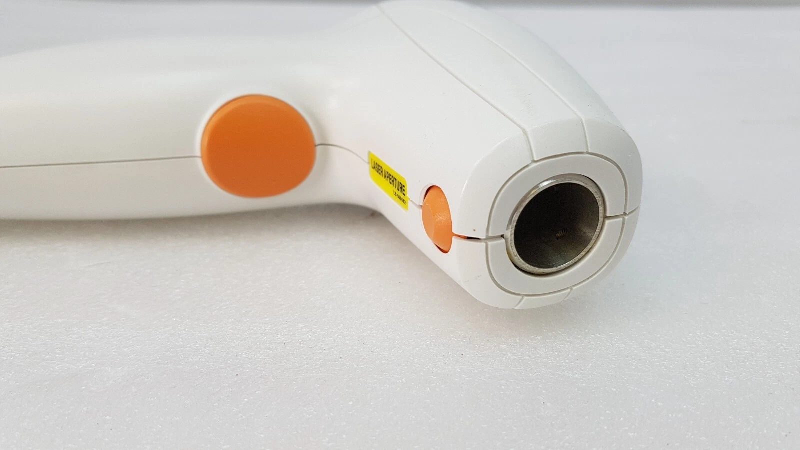 Round aperture and orange button on the front of the ResurFX handpiece