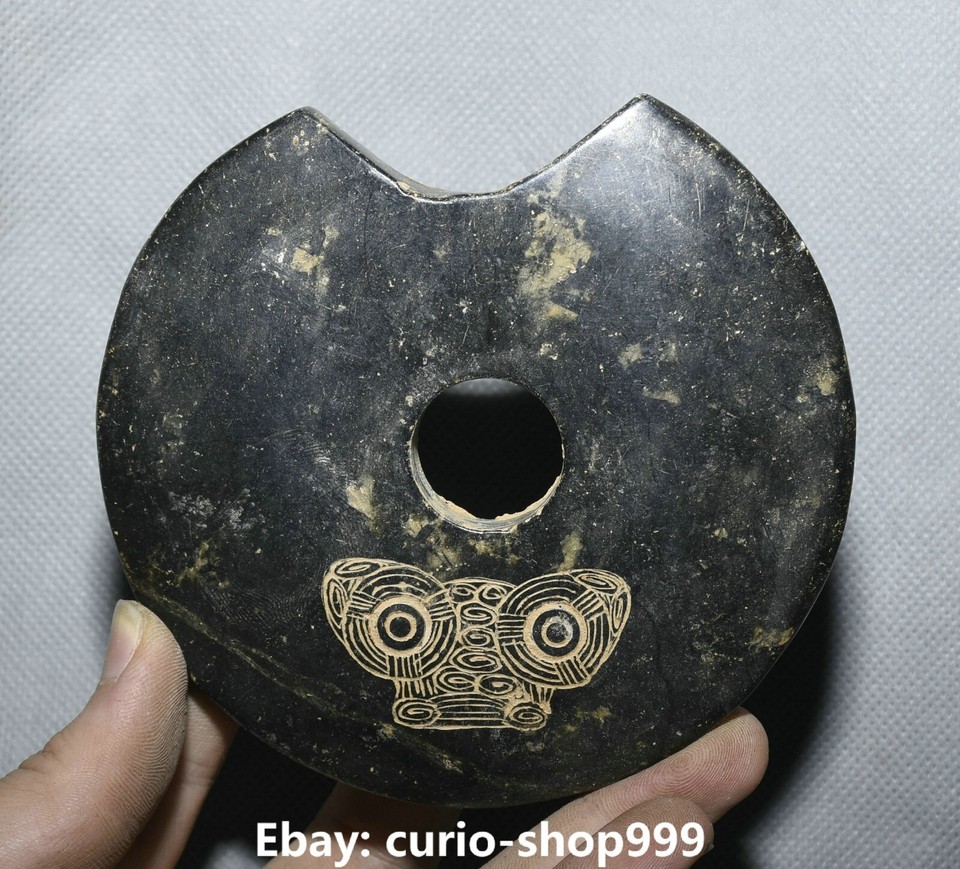 A palm-sized ancient-style jade-carved beast head bi disc — the kind of mysterious object that sits on a shelf and makes every visitor ask 'what IS that?'